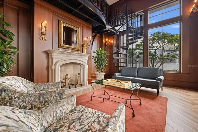 a living room with furniture fireplace and a large window