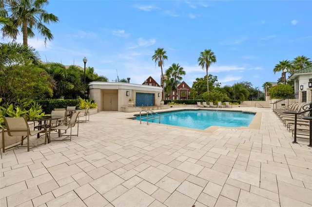 a view of a house with swimming pool and sitting area