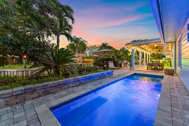 a view of swimming pool with sitting area