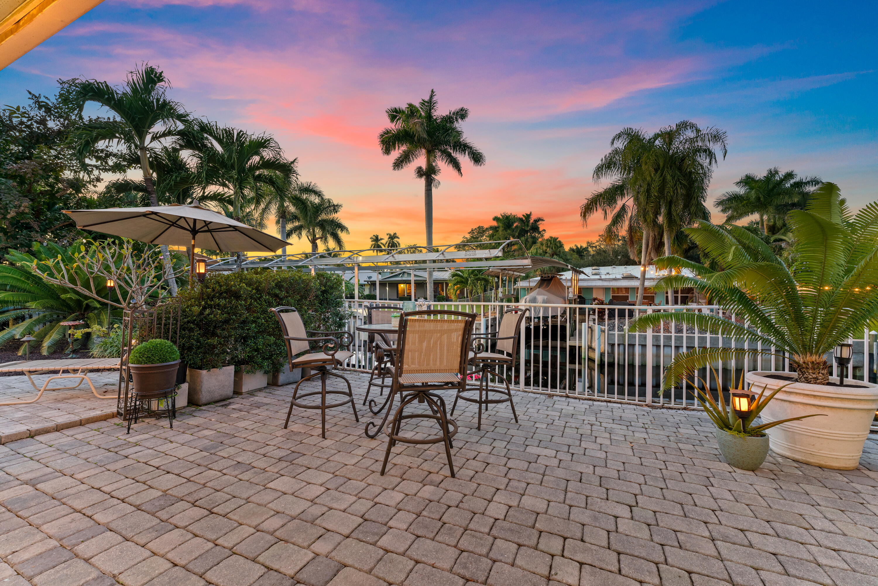 581 Southwest Timber Trail Stuart, FL 34997 - Photo 14 of 45 a view of a patio with a table and chairs and potted plants