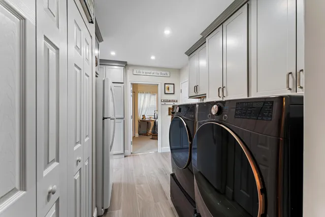 a white refrigerator freezer and a table in a kitchen