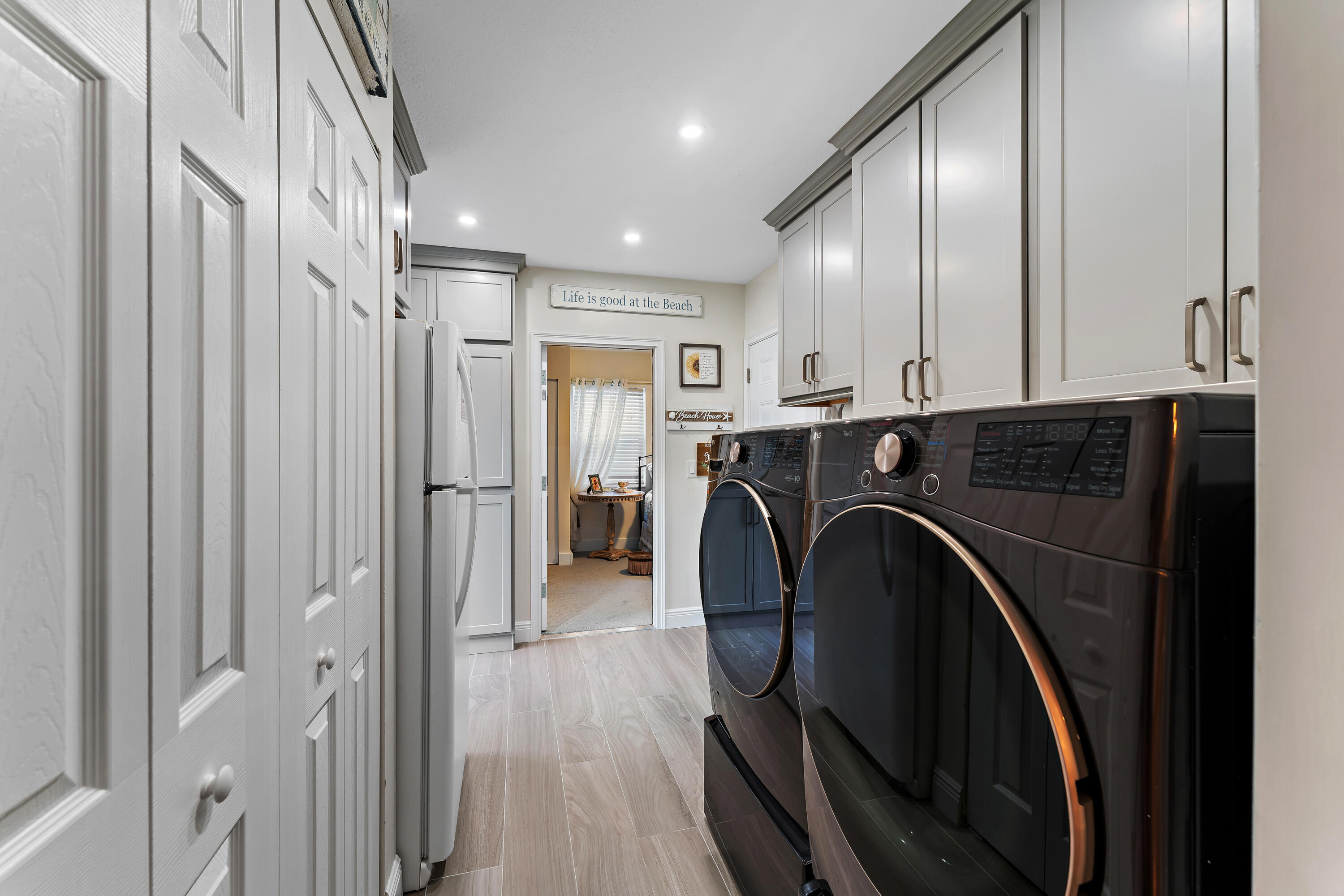 581 Southwest Timber Trail Stuart, FL 34997 - Photo 23 of 45 a utility room with wooden floor washer and dryer