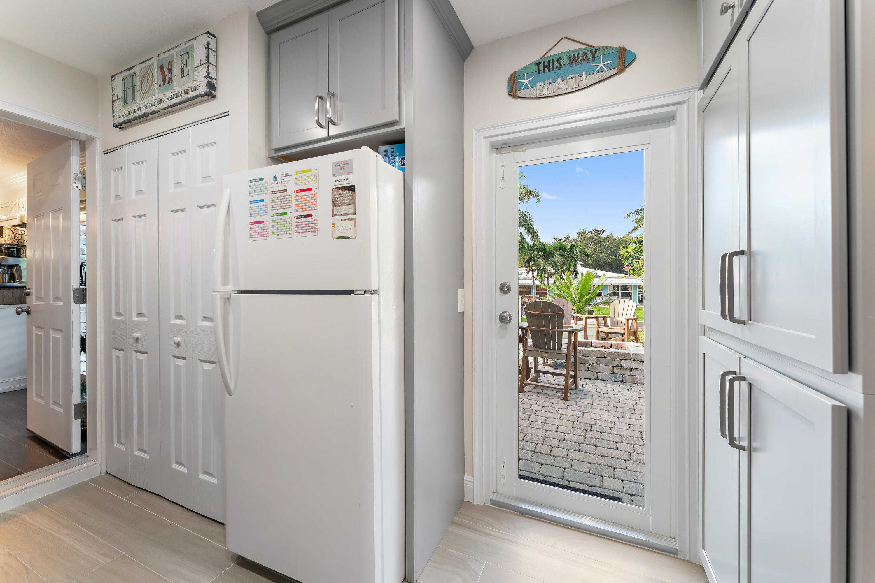 581 Southwest Timber Trail Stuart, FL 34997 - Photo 25 of 45 a white refrigerator freezer and a table in a kitchen