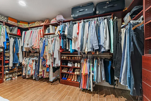 a bathroom with a granite countertop toilet sink and mirror