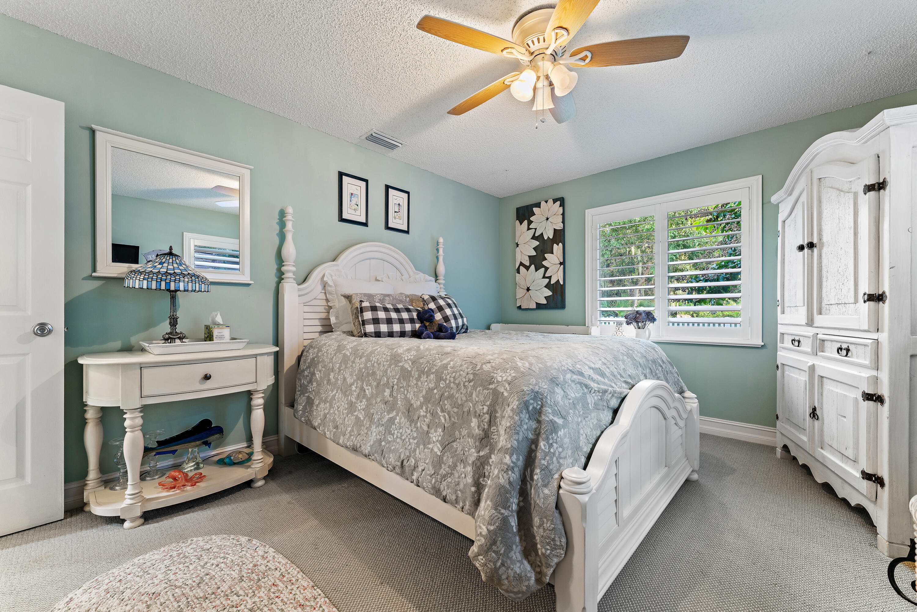 581 Southwest Timber Trail Stuart, FL 34997 - Photo 39 of 45 a bedroom with a bed and a chandelier