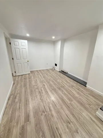 a view of an empty room and wooden floor