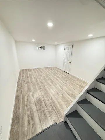 an empty room with wooden floor