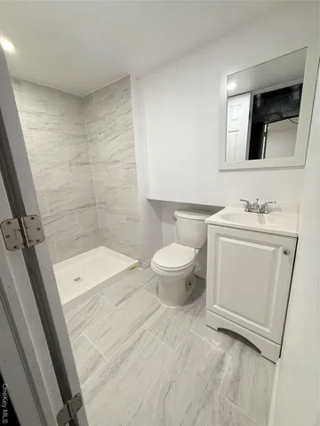 a bathroom with a sink a toilet and mirror