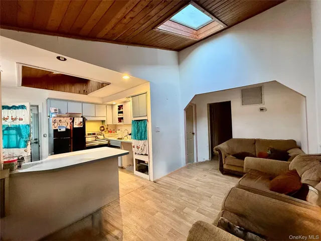a living room with furniture and kitchen view