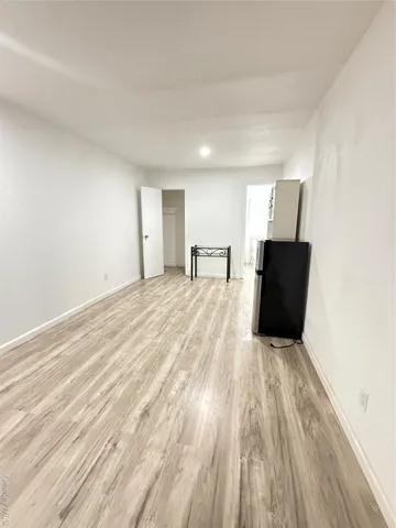 a view of a livingroom with wooden floor and a cabinet