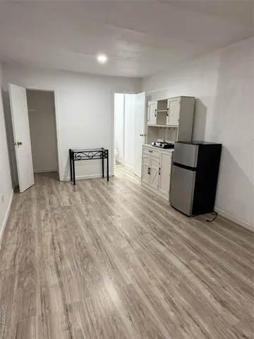 a view of kitchen with cabinets and wooden floor