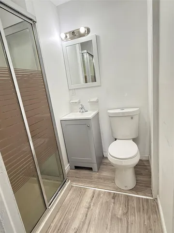 a bathroom with a toilet a sink and mirror