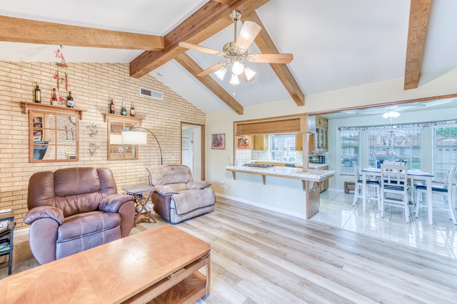 2367 Frederick Way Madera, CA 93637 - Photo 15 of 30 a living room with furniture a wooden floor and a large window