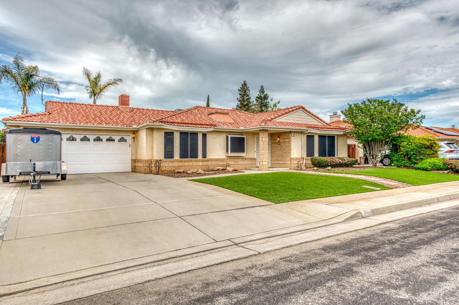 2367 Frederick Way Madera, CA 93637 - Photo 2 of 30 a front view of a house with a yard and garage