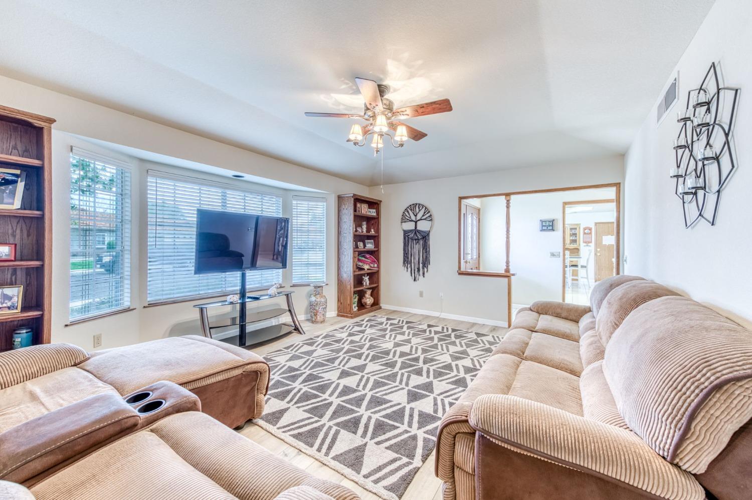 2367 Frederick Way Madera, CA 93637 - Photo 7 of 30 a living room with furniture and a flat screen tv