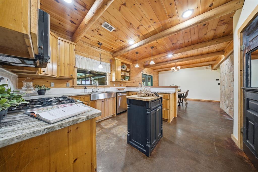 465 Emberson Ranch Road Pilot Point, TX 76258 - Photo 11 of 40 a kitchen filled with stainless steel appliances granite countertop a sink a stove and a refrigerator