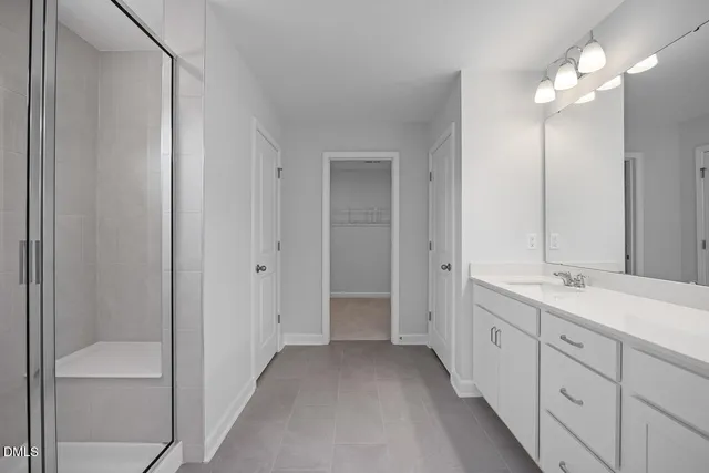 a bathroom with a double vanity sink and a mirror