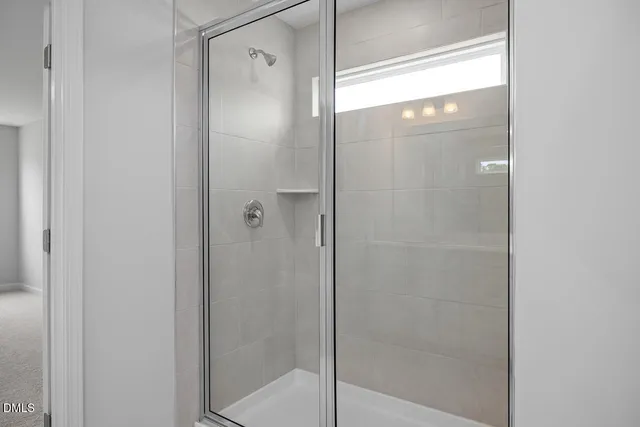 a bathroom with a glass shower door