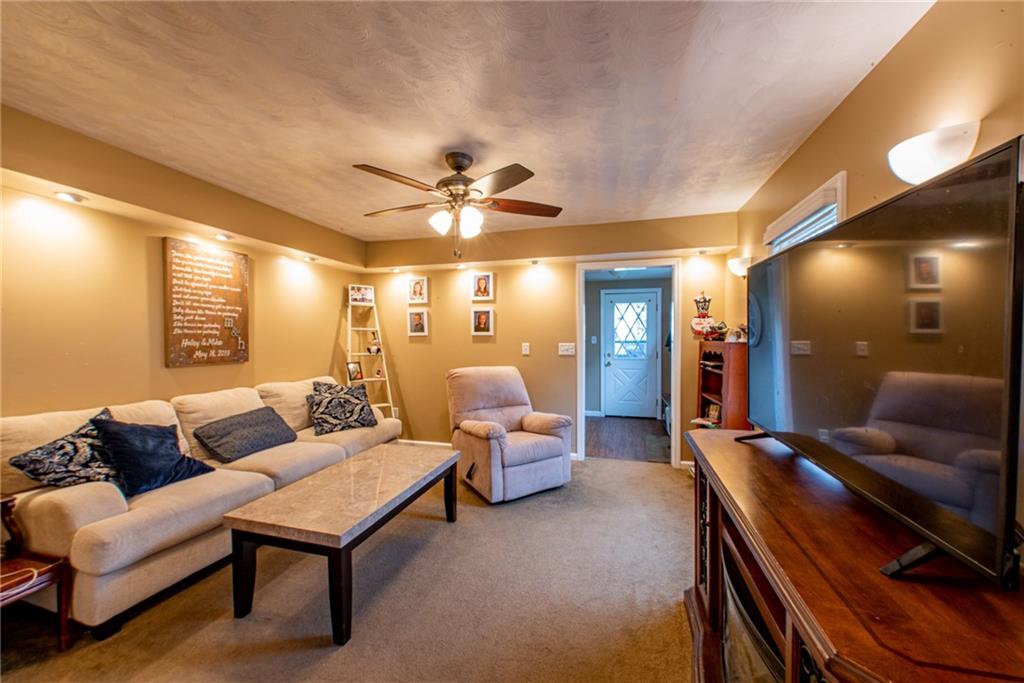 44 Rowe Street Rural Ridge, PA 15075 - Photo 12 of 25 a living room with furniture and a chandelier