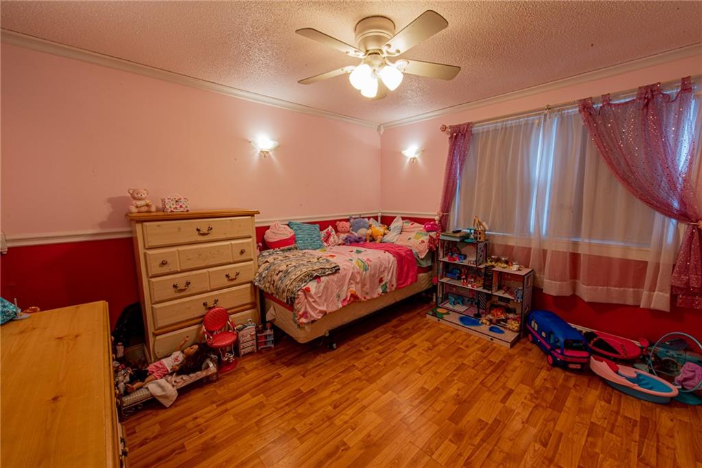 44 Rowe Street Rural Ridge, PA 15075 - Photo 20 of 25 a bedroom with a bed and a chandelier