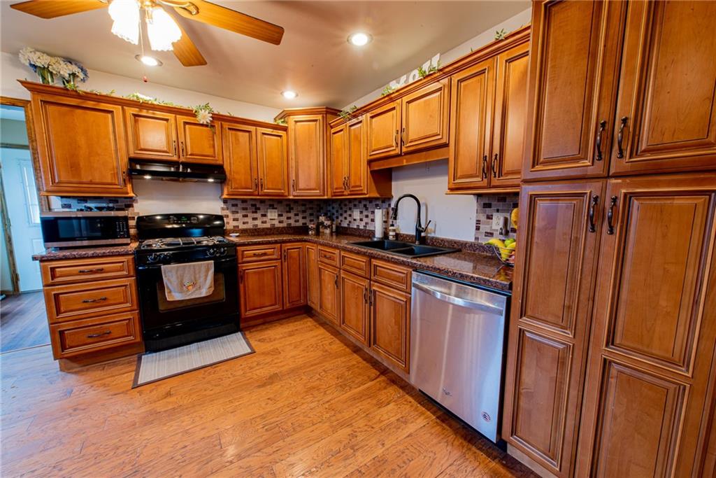 44 Rowe Street Rural Ridge, PA 15075 - Photo 3 of 25 a kitchen with stainless steel appliances granite countertop a stove top oven and sink