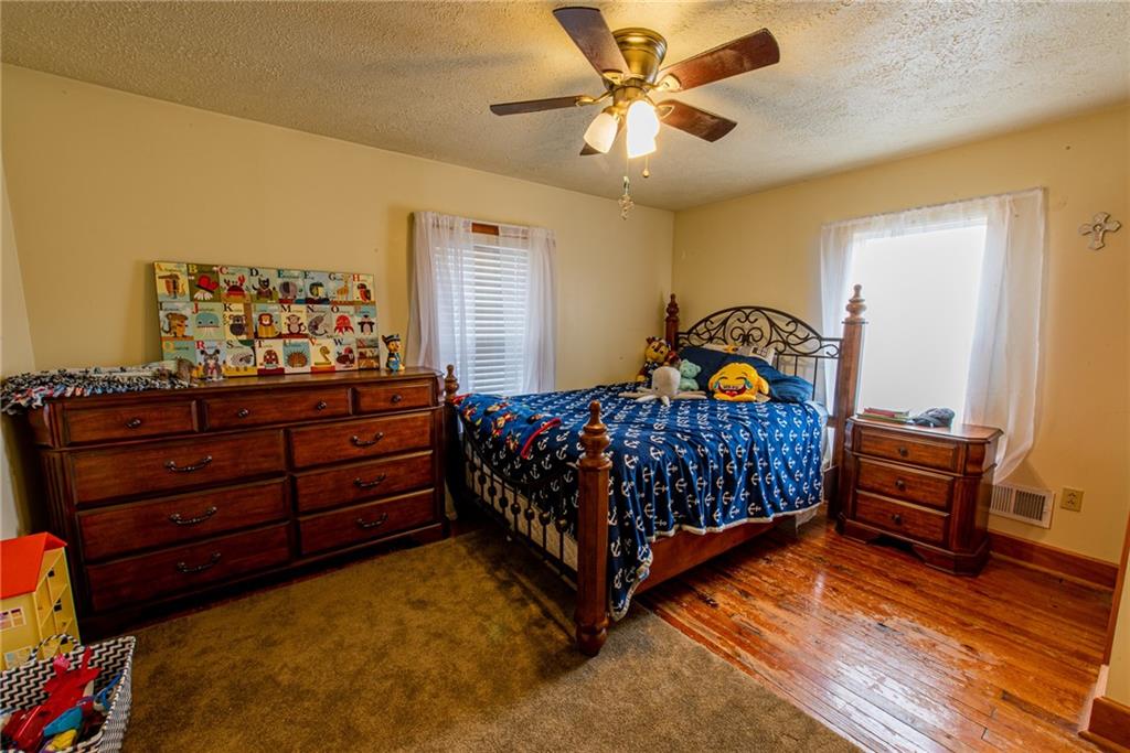 44 Rowe Street Rural Ridge, PA 15075 - Photo 22 of 25 a bedroom with a bed and a chandelier