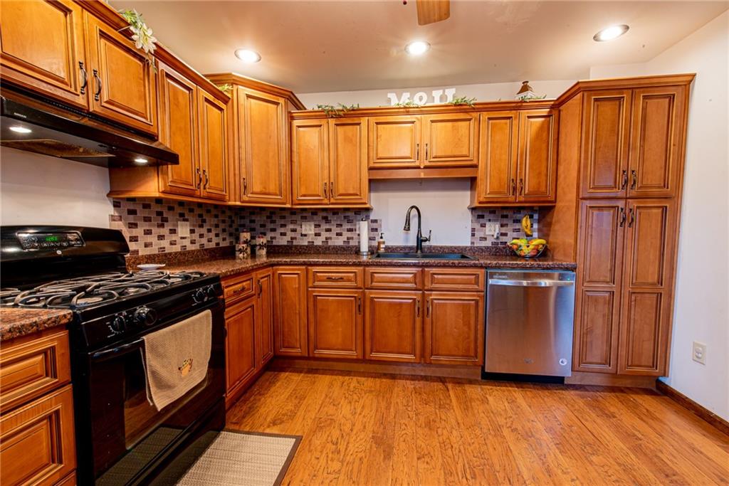 44 Rowe Street Rural Ridge, PA 15075 - Photo 5 of 25 a kitchen with stainless steel appliances granite countertop a stove a sink and a refrigerator