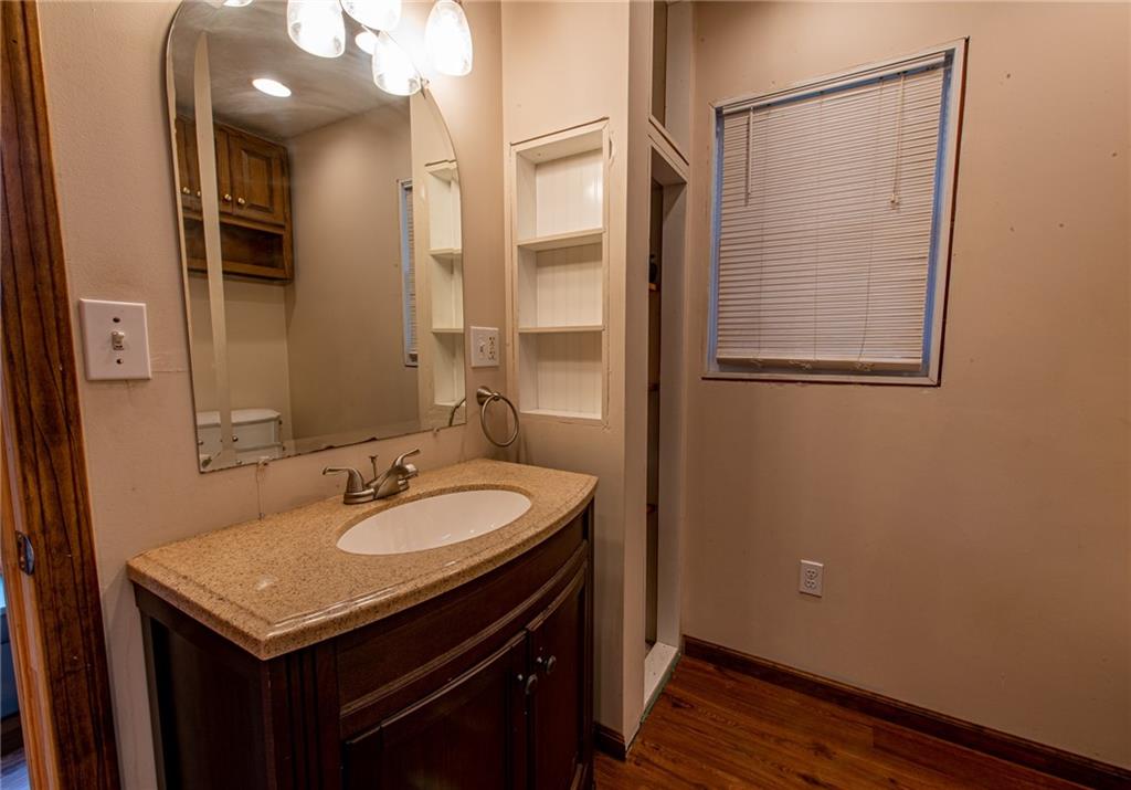 44 Rowe Street Rural Ridge, PA 15075 - Photo 7 of 25 a bathroom with a granite countertop sink shower and a mirror