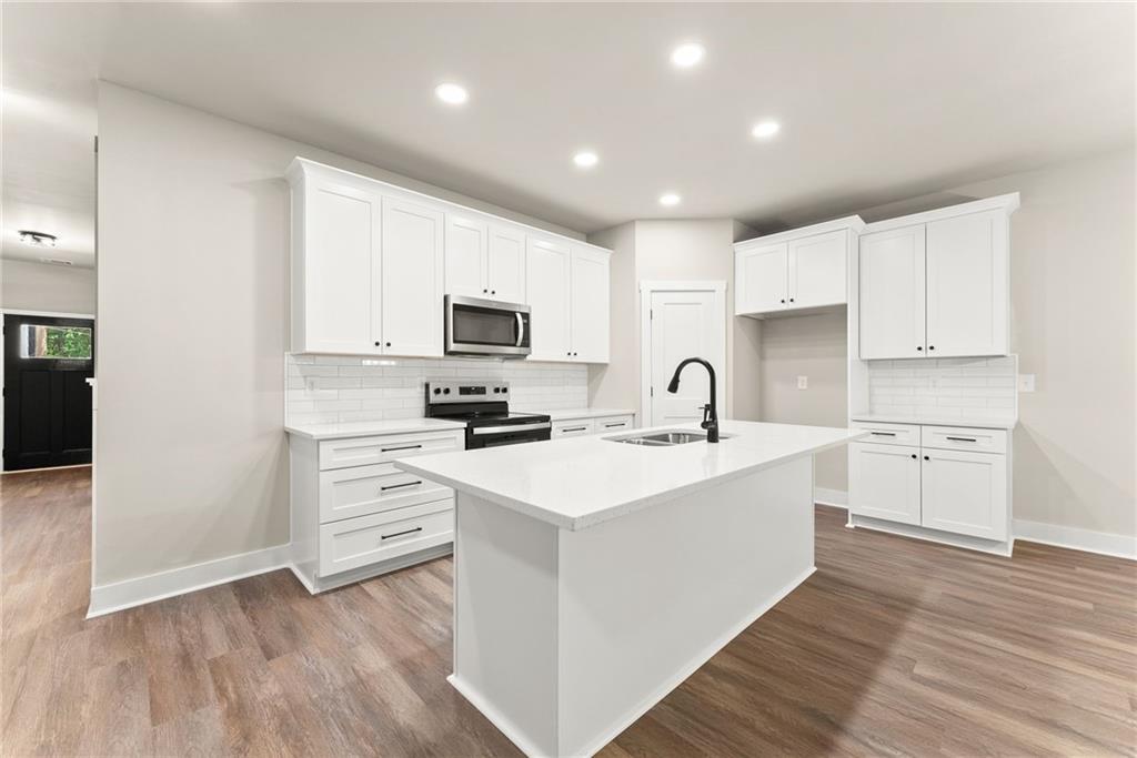 43 Anderson Street Jefferson, GA 30549 - Photo 7 of 45 a kitchen with white cabinets stainless steel appliances and sink