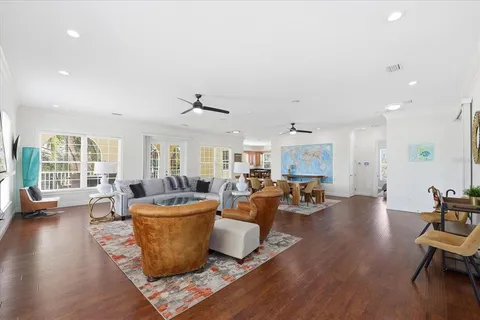 a living room with furniture and wooden floor