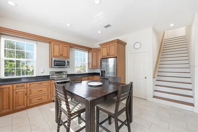 a kitchen with granite countertop a stove a sink and a granite counter tops