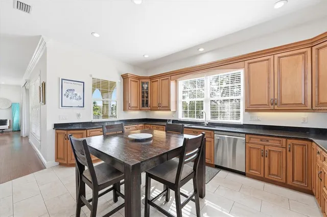 a bathroom with a granite countertop toilet sink and mirror