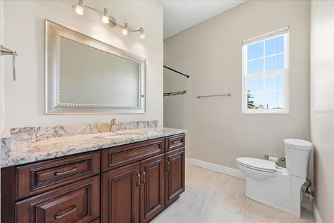 a bathroom with a toilet sink and shower