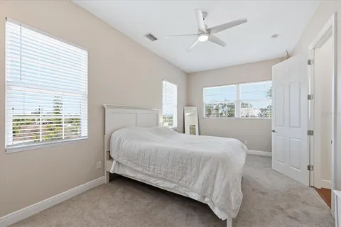 a spacious bedroom with a bed and a window