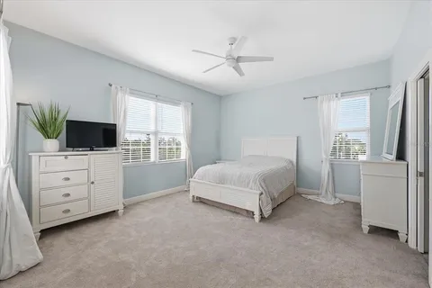 a spacious bedroom with a bed and a chandelier