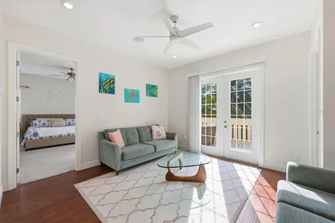 a bedroom with a large bed and a chandelier