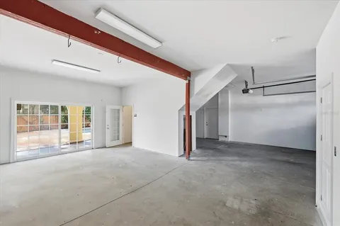 a view of a white house with a small yard and plants