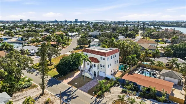 an aerial view of residential houses with outdoor space and street view