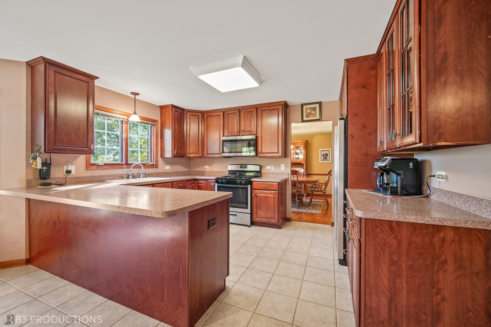 27325 South Kuersten Road Monee, IL 60449 - Photo 7 of 30 a kitchen with stainless steel appliances granite countertop wooden cabinets a stove top oven a sink and dishwasher