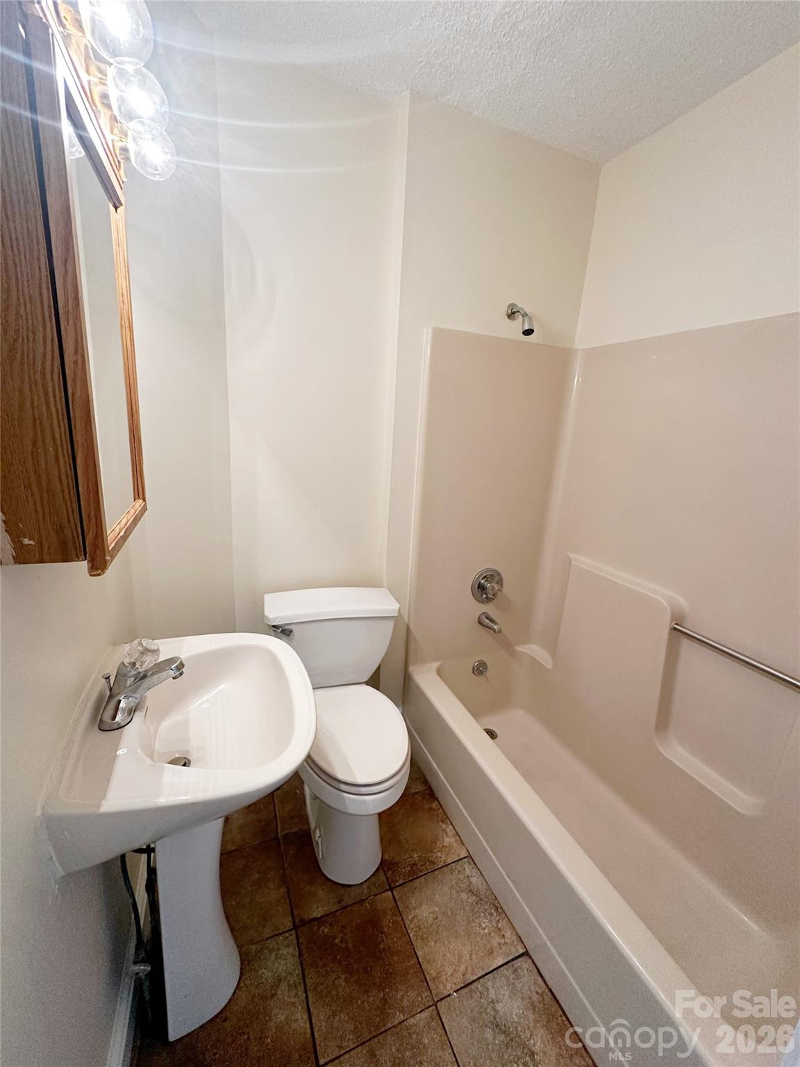 1803 West Main Street Albemarle, NC 28001 - Photo 11 of 13 a bathroom with a sink and mirror