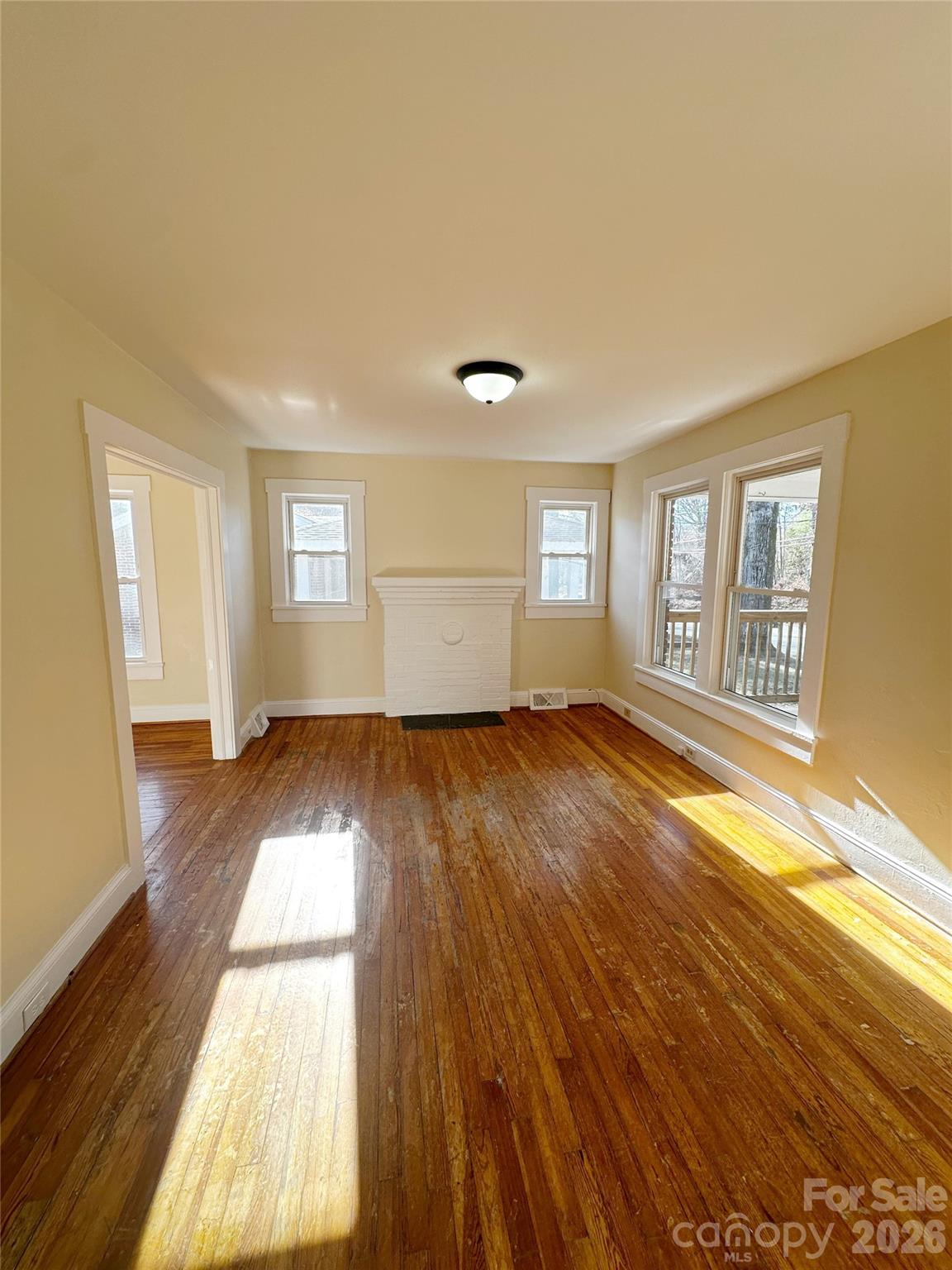 1803 West Main Street Albemarle, NC 28001 - Photo 3 of 13 a view of empty room with wooden floor and fan