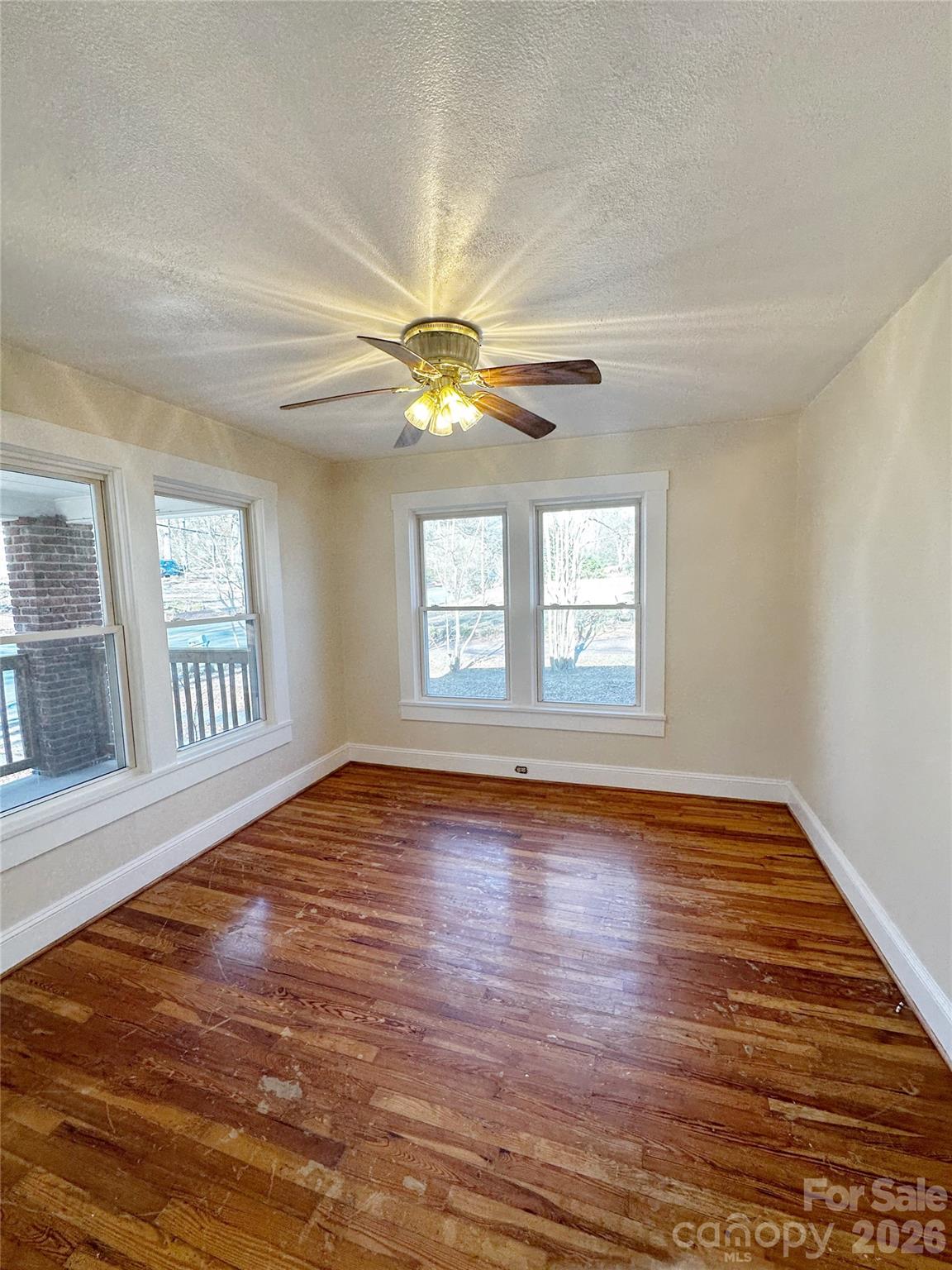 1803 West Main Street Albemarle, NC 28001 - Photo 4 of 13 a view of an empty room with wooden floor and a window