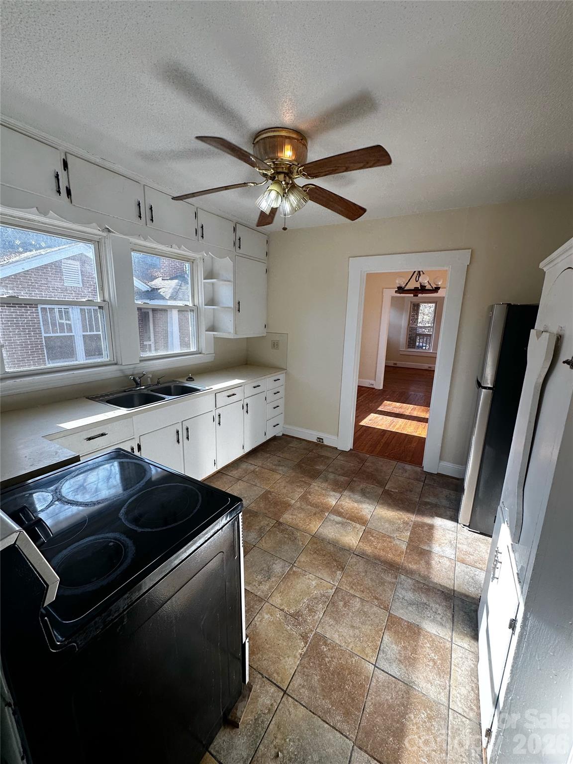 1803 West Main Street Albemarle, NC 28001 - Photo 5 of 13 a kitchen with stainless steel appliances granite countertop a sink stove and refrigerator