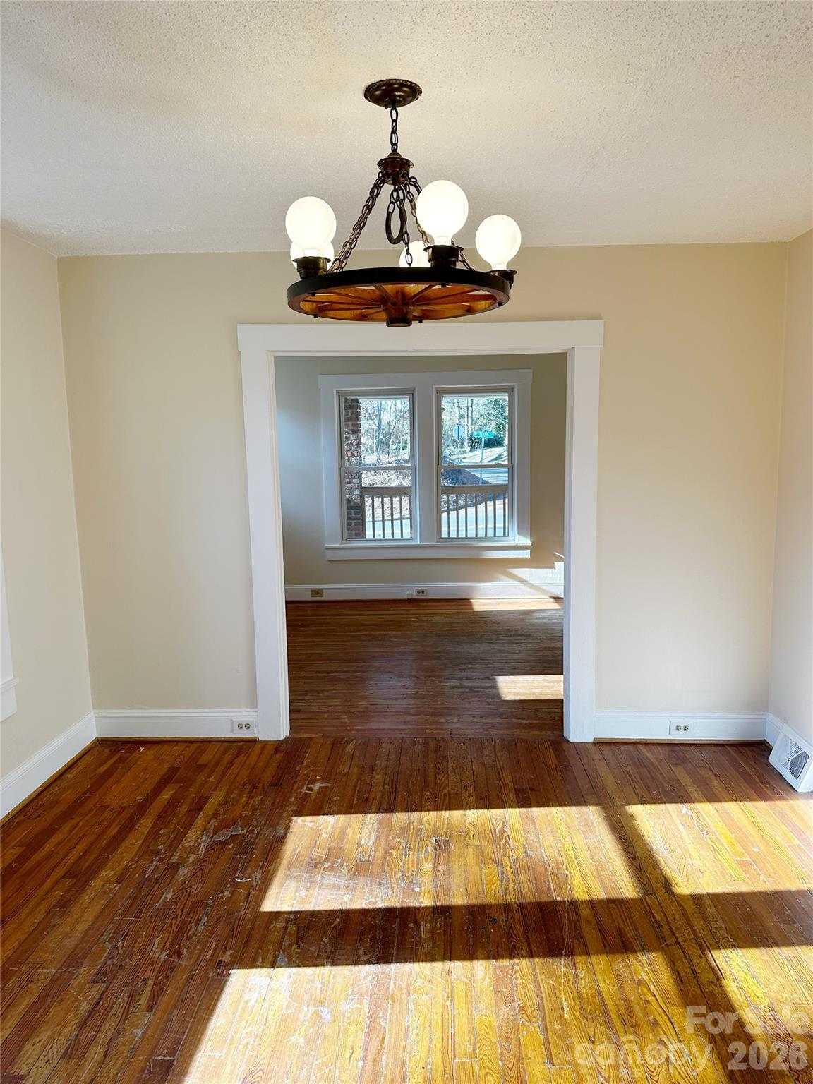 1803 West Main Street Albemarle, NC 28001 - Photo 7 of 13 a view of a hallway with wooden floor and a chandelier