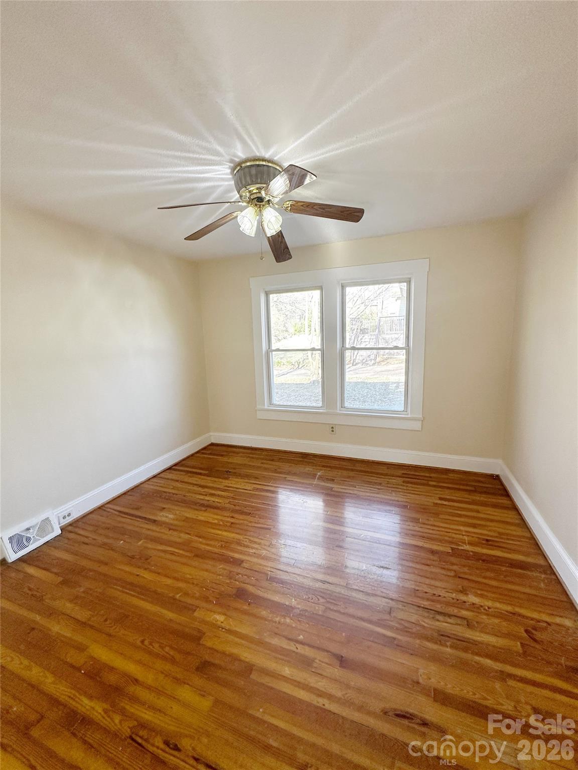 1803 West Main Street Albemarle, NC 28001 - Photo 8 of 13 a view of empty room with wooden floor and fan