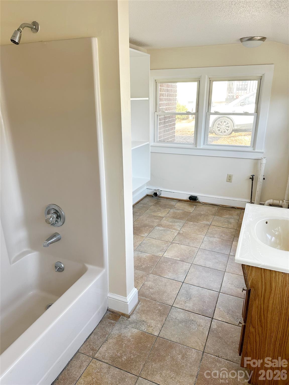 1803 West Main Street Albemarle, NC 28001 - Photo 10 of 13 a bathroom with a bathtub and a shower
