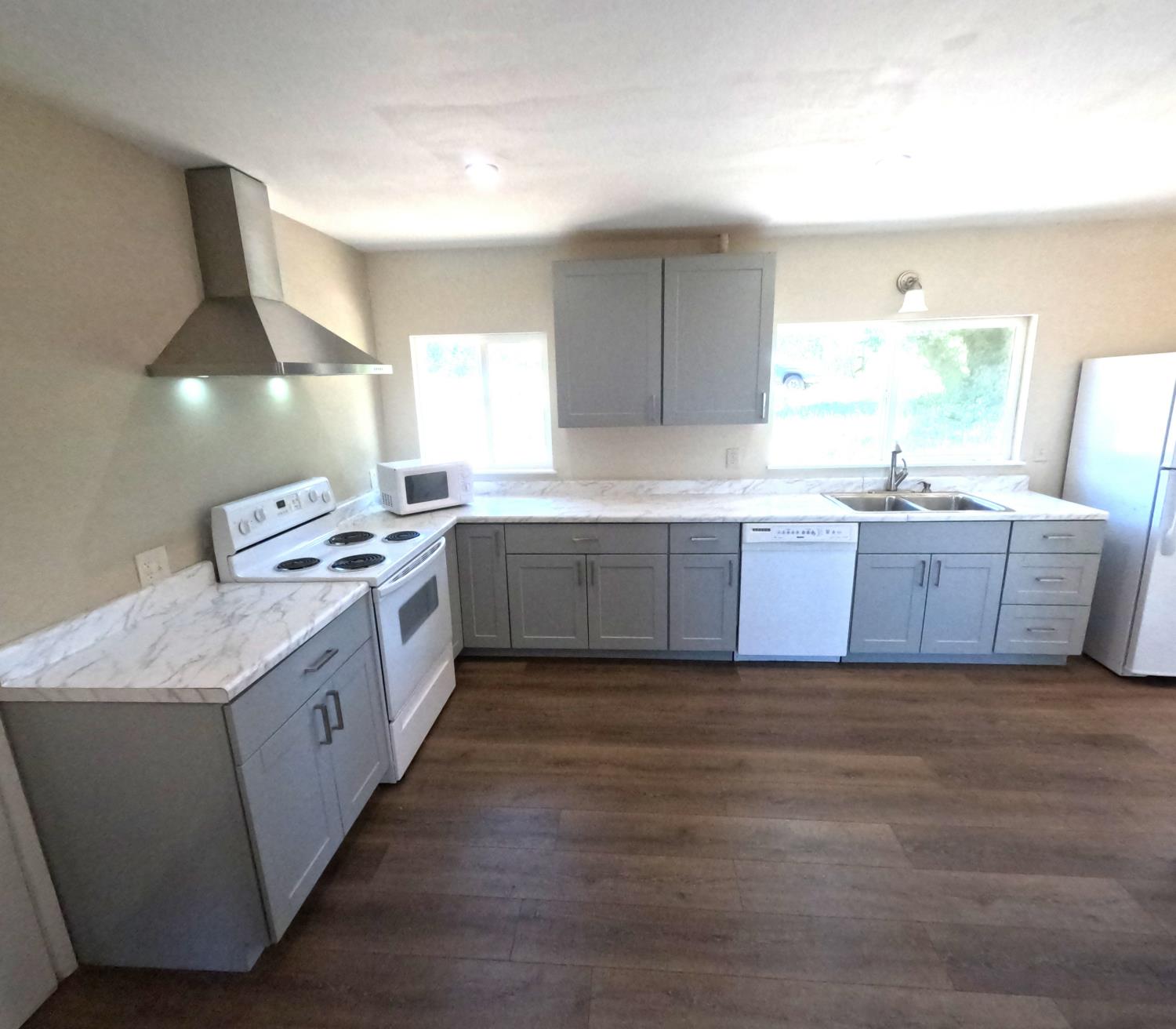 21665 Manton School Road Manton, CA 96059 - Photo 22 of 30 a kitchen with stainless steel appliances granite countertop a sink counter space and wooden floor