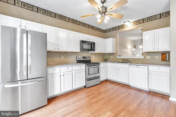 a kitchen with a refrigerator a sink and cabinets