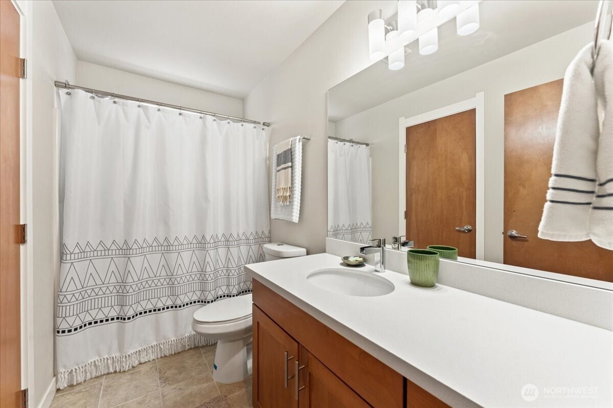 12418 2nd Place Southwest Burien, WA 98146 - Photo 22 of 39 a bathroom with a double vanity sink toilet and shower