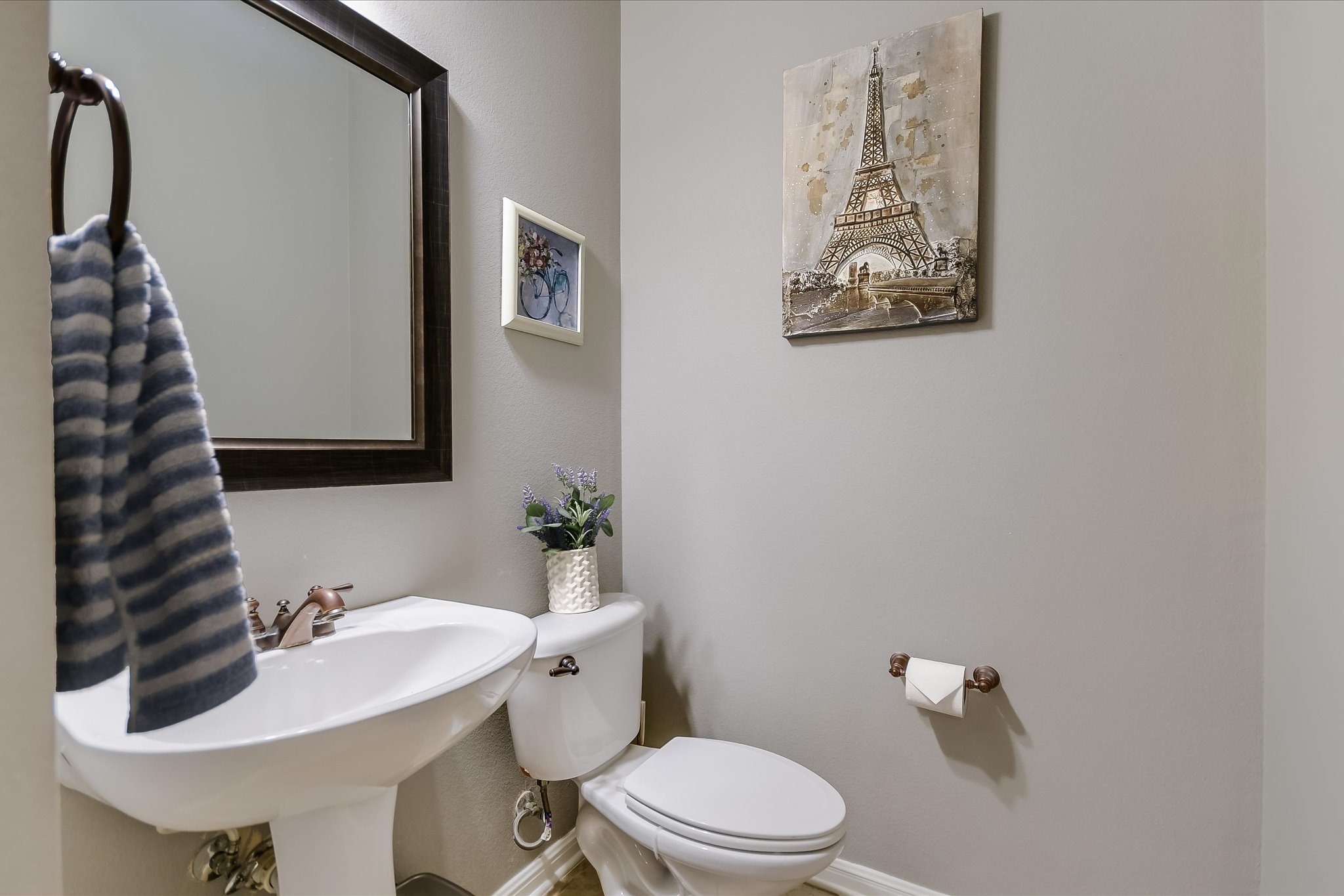300 Wesley Ridge Drive Spicewood, TX 78669 - Photo 25 of 40 The main-level powder room features a sleek pedestal sink and quick access from the living areas.